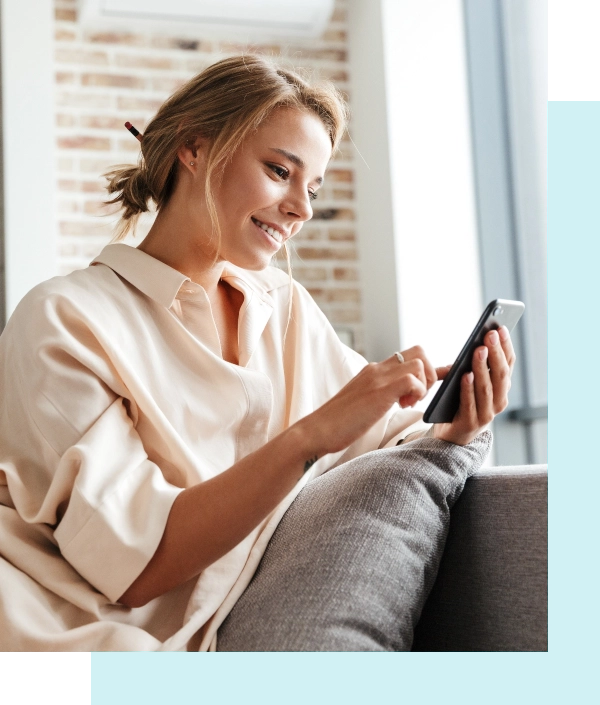 Woman scrolling phone couch