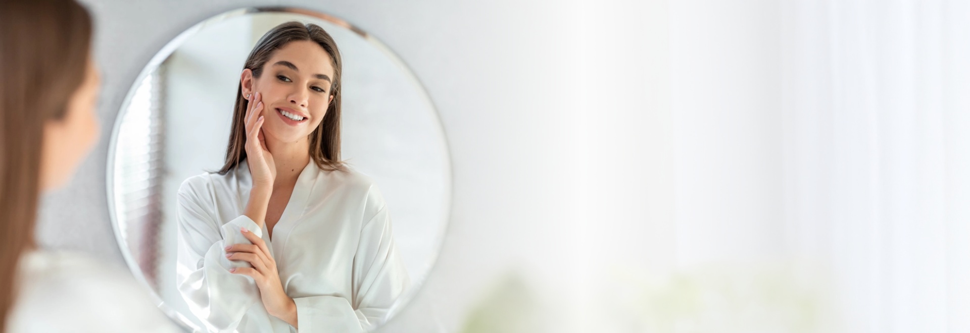 Young woman looking mirror